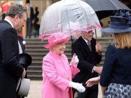 Queen Elizabeth Meets Guests at Buckingham Palace